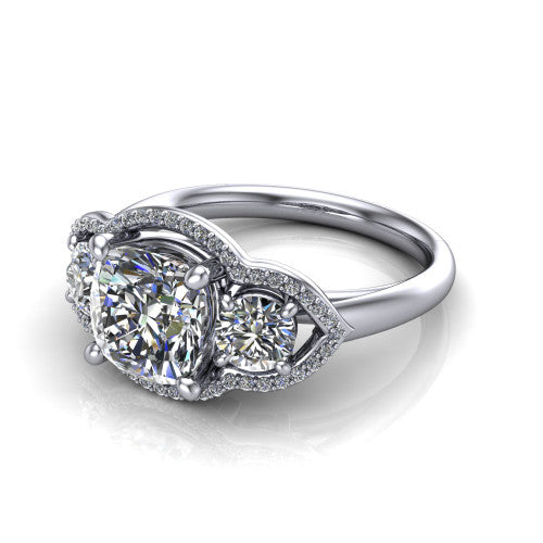 Kalani cushion halo engagement ring in Platinum, three-quarter perspective showing the haloed center and two haloed round side stones linked by open scroll bridges