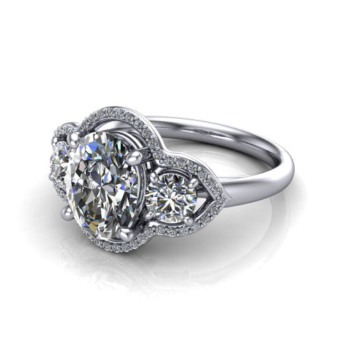 Kalani oval halo engagement ring in 18K White Gold, three-quarter perspective showing the haloed center and two haloed round side stones linked by open scroll bridges