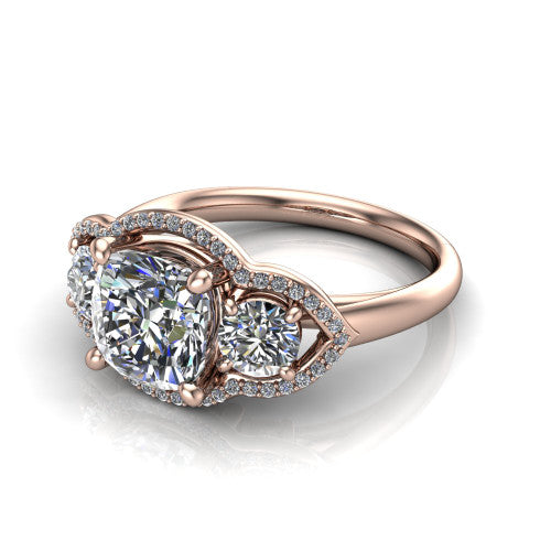 Kalani cushion halo engagement ring in 18K Rose Gold, three-quarter perspective showing the haloed center and two haloed round side stones linked by open scroll bridges