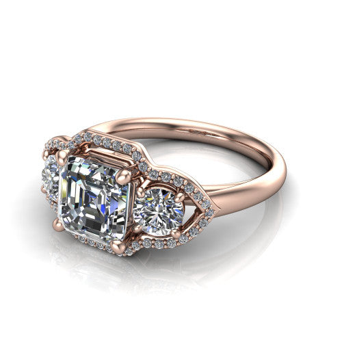 Kalani asscher halo engagement ring in 18K Rose Gold, three-quarter perspective showing the haloed center and two haloed round side stones linked by open scroll bridges