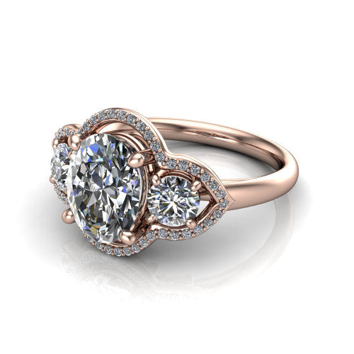 Kalani oval halo engagement ring in 18K Rose Gold, three-quarter perspective showing the haloed center and two haloed round side stones linked by open scroll bridges
