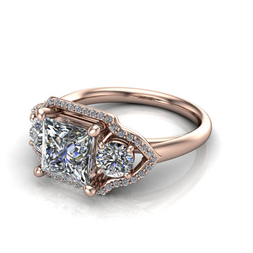 Kalani princess halo engagement ring in 14K Rose Gold, three-quarter perspective showing the haloed center and two haloed round side stones linked by open scroll bridges