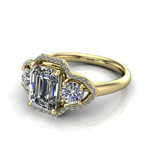 Kalani emerald halo engagement ring in 18K Yellow Gold, three-quarter perspective showing the haloed center and two haloed round side stones linked by open scroll bridges