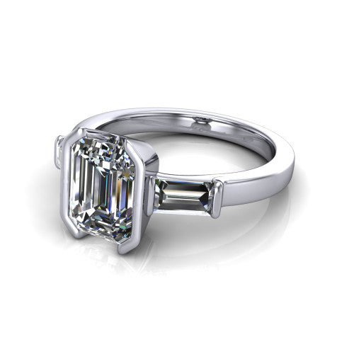 Amanda emerald three stone engagement ring in Platinum, three-quarter perspective showing the center diamond between two tapered baguette side stones on a slim polished band