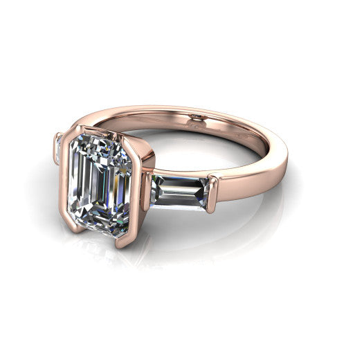 Amanda emerald three stone engagement ring in 14K Rose Gold, three-quarter perspective showing the center diamond between two tapered baguette side stones on a slim polished band