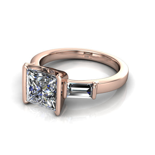 Amanda princess three stone engagement ring in 18K Rose Gold, three-quarter perspective showing the center diamond between two tapered baguette side stones on a slim polished band