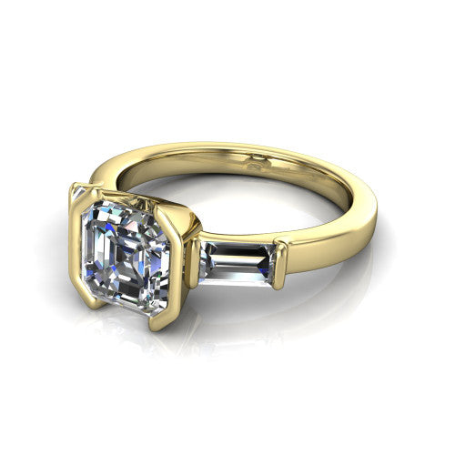 Amanda asscher three stone engagement ring in 18K Yellow Gold, three-quarter perspective showing the center diamond between two tapered baguette side stones on a slim polished band