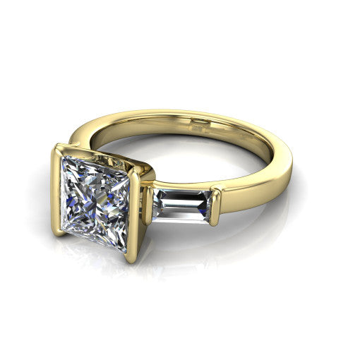 Amanda princess three stone engagement ring in 18K Yellow Gold, three-quarter perspective showing the center diamond between two tapered baguette side stones on a slim polished band