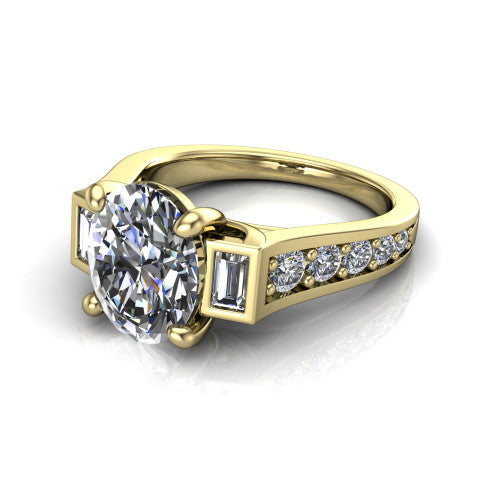 Estella oval three stone engagement ring in 18K Yellow Gold, three-quarter perspective showing the center diamond between two tapered baguette side stones above a pav&eacute; band