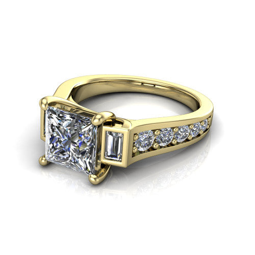 Estella princess three stone engagement ring in 14K Yellow Gold, three-quarter perspective showing the center diamond between two tapered baguette side stones above a pav&eacute; band