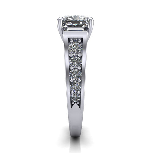 Estella cushion three stone engagement ring in 18K White Gold, side profile showing the tapered baguette side stone and the round diamonds running down the shank