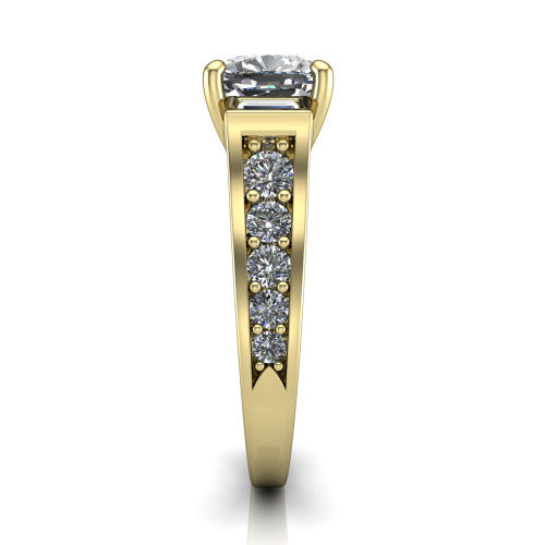 Estella cushion three stone engagement ring in 18K Yellow Gold, side profile showing the tapered baguette side stone and the round diamonds running down the shank