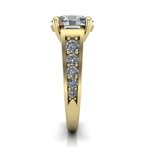 Estella oval three stone engagement ring in 18K Yellow Gold, side profile showing the tapered baguette side stone and the round diamonds running down the shank