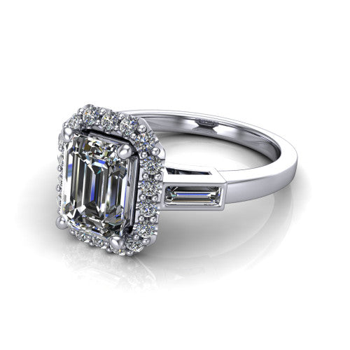 Lorelai emerald halo engagement ring in Platinum, three-quarter perspective showing the haloed center between two tapered baguette side stones on a slim polished band