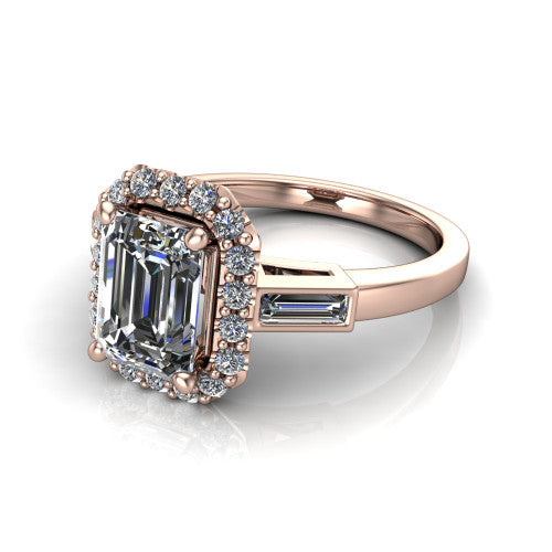 Lorelai emerald halo engagement ring in 14K Rose Gold, three-quarter perspective showing the haloed center between two tapered baguette side stones on a slim polished band