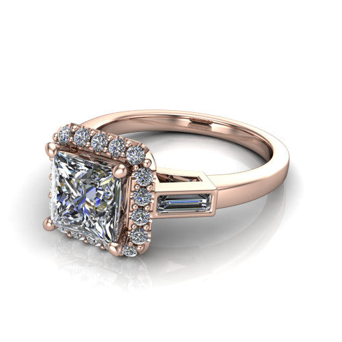 Lorelai princess halo engagement ring in 14K Rose Gold, three-quarter perspective showing the haloed center between two tapered baguette side stones on a slim polished band