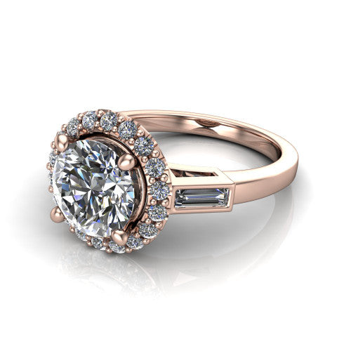 Lorelai round halo engagement ring in 18K Rose Gold, three-quarter perspective showing the haloed center between two tapered baguette side stones on a slim polished band