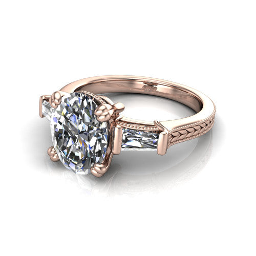 Camille oval three stone engagement ring in 14K Rose Gold, three-quarter perspective showing the center diamond between two tapered baguette side stones above a hand-engraved band
