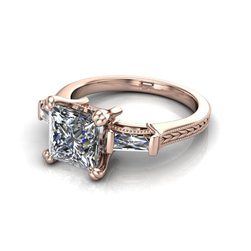 Camille princess three stone engagement ring in 14K Rose Gold, three-quarter perspective showing the center diamond between two tapered baguette side stones above a hand-engraved band
