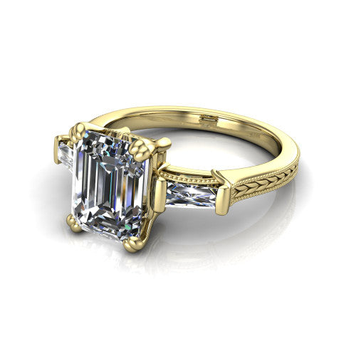 Camille emerald three stone engagement ring in 14K Yellow Gold, three-quarter perspective showing the center diamond between two tapered baguette side stones above a hand-engraved band