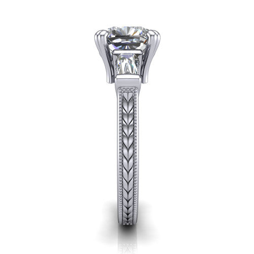 Camille cushion three stone engagement ring in 18K White Gold, side profile showing the tapered baguette side stone and the hand-engraved wheat pattern down the band