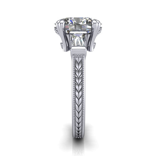 Camille oval three stone engagement ring in Platinum, side profile showing the tapered baguette side stone and the hand-engraved wheat pattern down the band