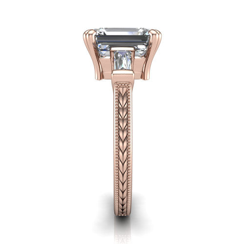 Camille emerald three stone engagement ring in 18K Rose Gold, side profile showing the tapered baguette side stone and the hand-engraved wheat pattern down the band