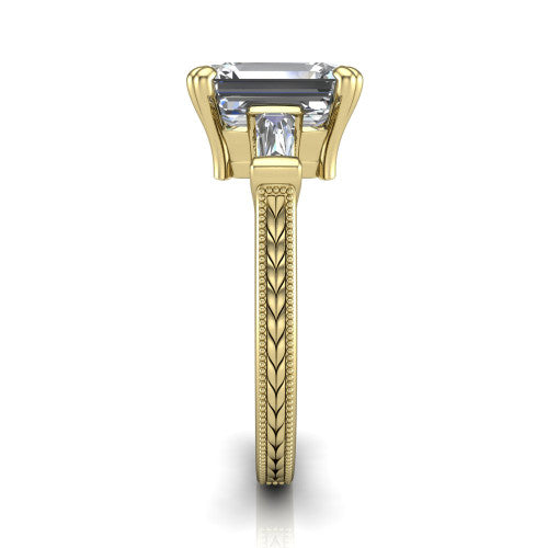 Camille emerald three stone engagement ring in 14K Yellow Gold, side profile showing the tapered baguette side stone and the hand-engraved wheat pattern down the band