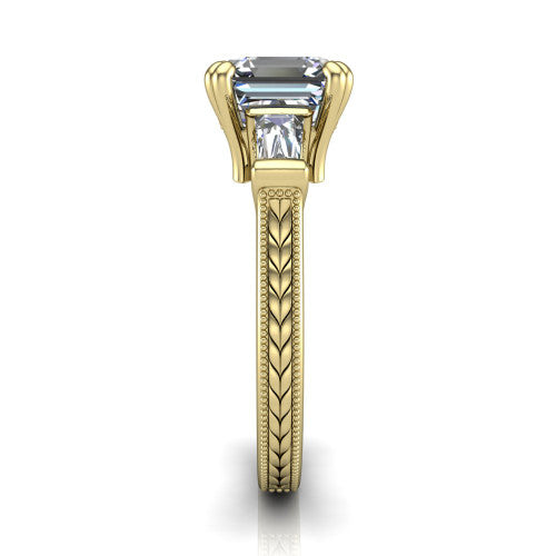 Camille asscher three stone engagement ring in 18K Yellow Gold, side profile showing the tapered baguette side stone and the hand-engraved wheat pattern down the band