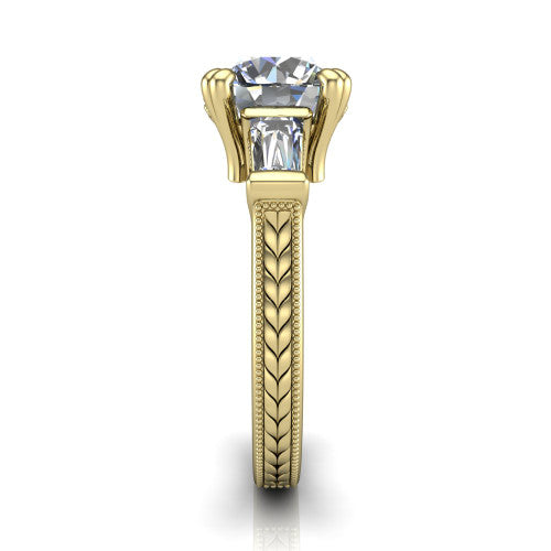 Camille round three stone engagement ring in 14K Yellow Gold, side profile showing the tapered baguette side stone and the hand-engraved wheat pattern down the band