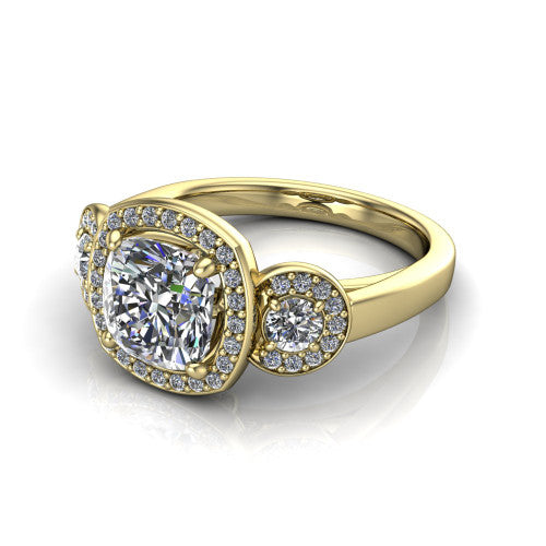 Wrenley cushion three stone engagement ring in 18K Yellow Gold, three-quarter perspective showing the haloed center between two haloed round side stones on a polished band