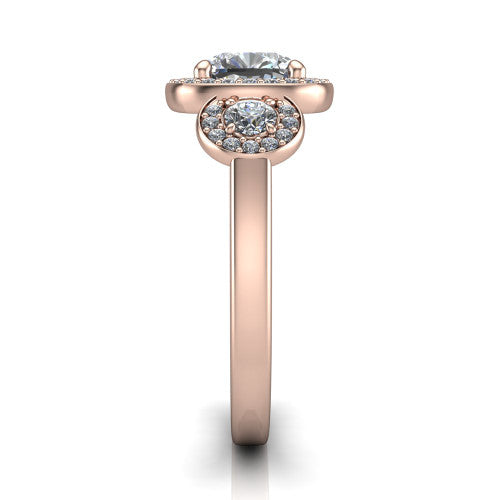 Wrenley cushion three stone engagement ring in 14K Rose Gold, side profile showing a haloed round side stone and the smooth polished band