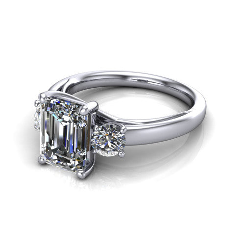 Alyssa emerald classic engagement ring in 18K White Gold, three-quarter perspective showing the center diamond between two round side stones on a slim polished band