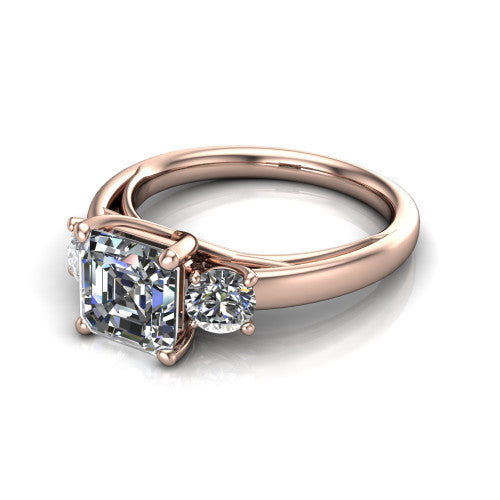 Alyssa asscher classic engagement ring in 14K Rose Gold, three-quarter perspective showing the center diamond between two round side stones on a slim polished band