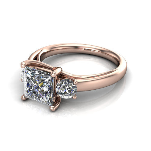 Alyssa princess classic engagement ring in 14K Rose Gold, three-quarter perspective showing the center diamond between two round side stones on a slim polished band