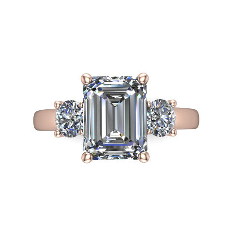 Alyssa emerald classic engagement ring in 18K Rose Gold, top-down view showing the center diamond flanked by two round side stones in a classic three stone setting