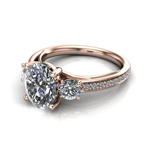 London oval classic engagement ring in 18K Rose Gold, three-quarter perspective showing the center diamond between two round side stones above a pav&eacute; shank