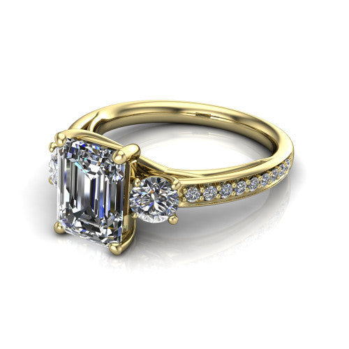 London emerald classic engagement ring in 14K Yellow Gold, three-quarter perspective showing the center diamond between two round side stones above a pav&eacute; shank