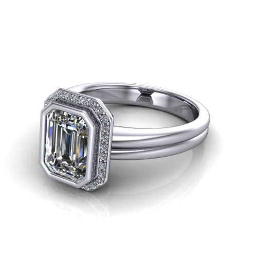 Maggie emerald halo engagement ring in 14K White Gold, three-quarter perspective showing the bezel-set center framed by a pav&eacute; halo on a polished double-rail shank
