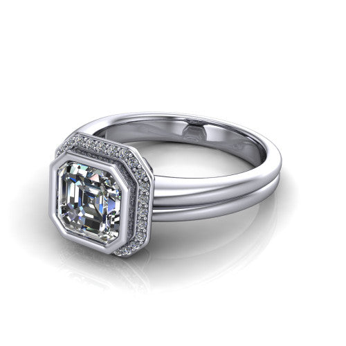 Maggie asscher halo engagement ring in 14K White Gold, three-quarter perspective showing the bezel-set center framed by a pav&eacute; halo on a polished double-rail shank
