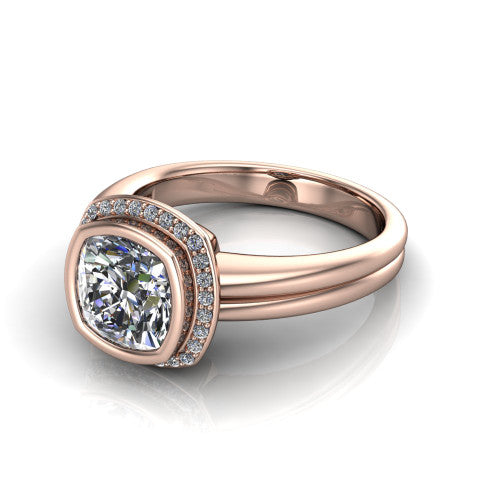 Maggie cushion halo engagement ring in 18K Rose Gold, three-quarter perspective showing the bezel-set center framed by a pav&eacute; halo on a polished double-rail shank