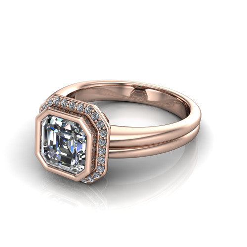 Maggie asscher halo engagement ring in 14K Rose Gold, three-quarter perspective showing the bezel-set center framed by a pav&eacute; halo on a polished double-rail shank