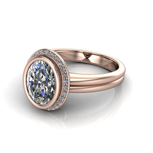 Maggie oval halo engagement ring in 18K Rose Gold, three-quarter perspective showing the bezel-set center framed by a pav&eacute; halo on a polished double-rail shank