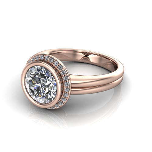 Maggie round halo engagement ring in 18K Rose Gold, three-quarter perspective showing the bezel-set center framed by a pav&eacute; halo on a polished double-rail shank
