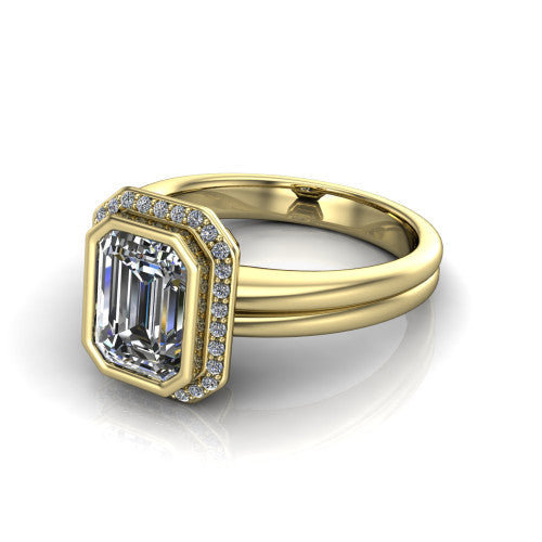 Maggie emerald halo engagement ring in 14K Yellow Gold, three-quarter perspective showing the bezel-set center framed by a pav&eacute; halo on a polished double-rail shank