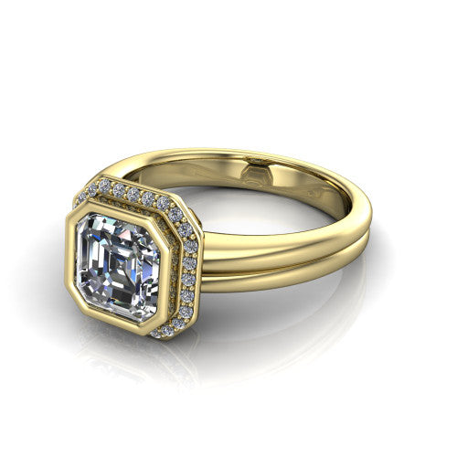 Maggie asscher halo engagement ring in 14K Yellow Gold, three-quarter perspective showing the bezel-set center framed by a pav&eacute; halo on a polished double-rail shank