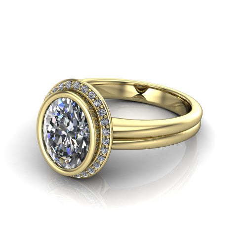 Maggie oval halo engagement ring in 18K Yellow Gold, three-quarter perspective showing the bezel-set center framed by a pav&eacute; halo on a polished double-rail shank