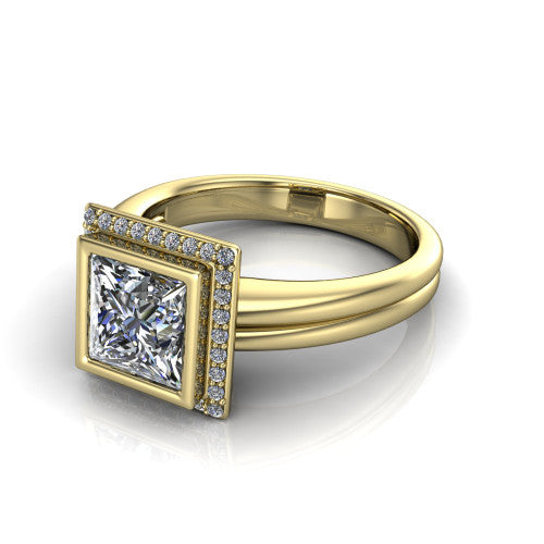 Maggie princess halo engagement ring in 14K Yellow Gold, three-quarter perspective showing the bezel-set center framed by a pav&eacute; halo on a polished double-rail shank