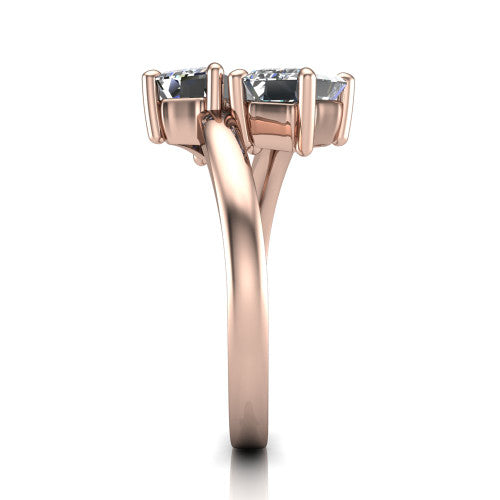 Adelaide emerald three stone engagement ring in 18K Rose Gold, side profile showing the slim single bypass band swirling beneath the two-stone head