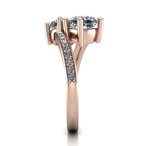 Payton cushion three stone engagement ring in 14K Rose Gold, side profile showing the pav&eacute; split shank crossing in a bypass beneath the two-stone head